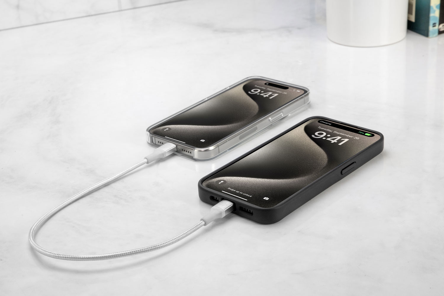 two iphones syncing via Scosche braided cable on countertop