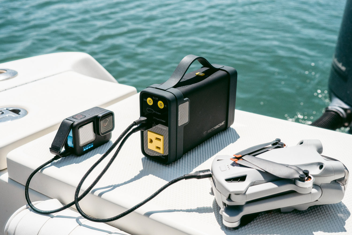 portable game and GoPro camera charging on boat via Scosche portable power bank