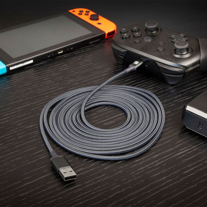 gaming cable braided cable plugged into game controller next to hand held game