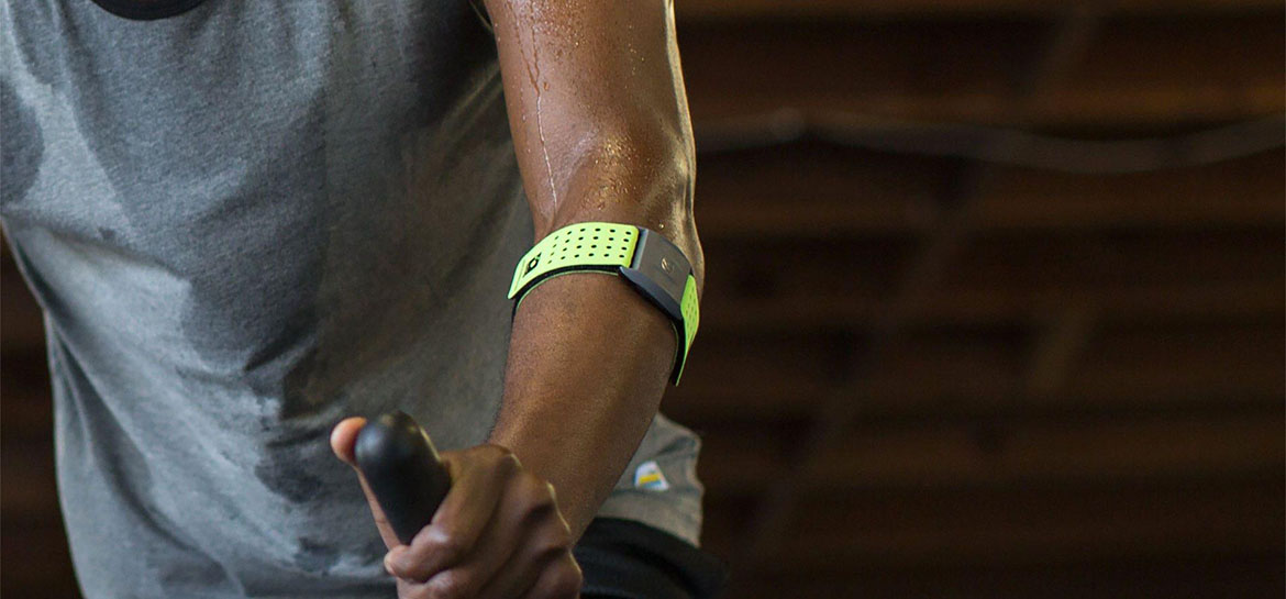 Scosche Rhythm+ Armband Heart Rate Monitor close up of man wearing Scosche Rhythm+ Armband Heart Rate Monitor while on treadmill