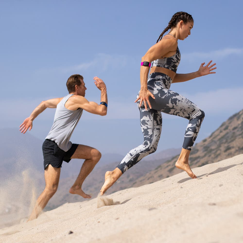 running with heart rate monitor armband man and woman running with heart rate monitor armband